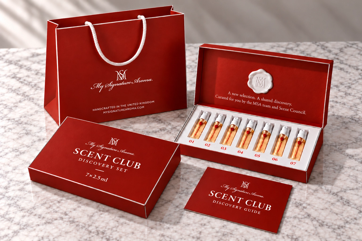 Red MSA bag, Scent Club Discovery Set and discovery guide on a marble counter